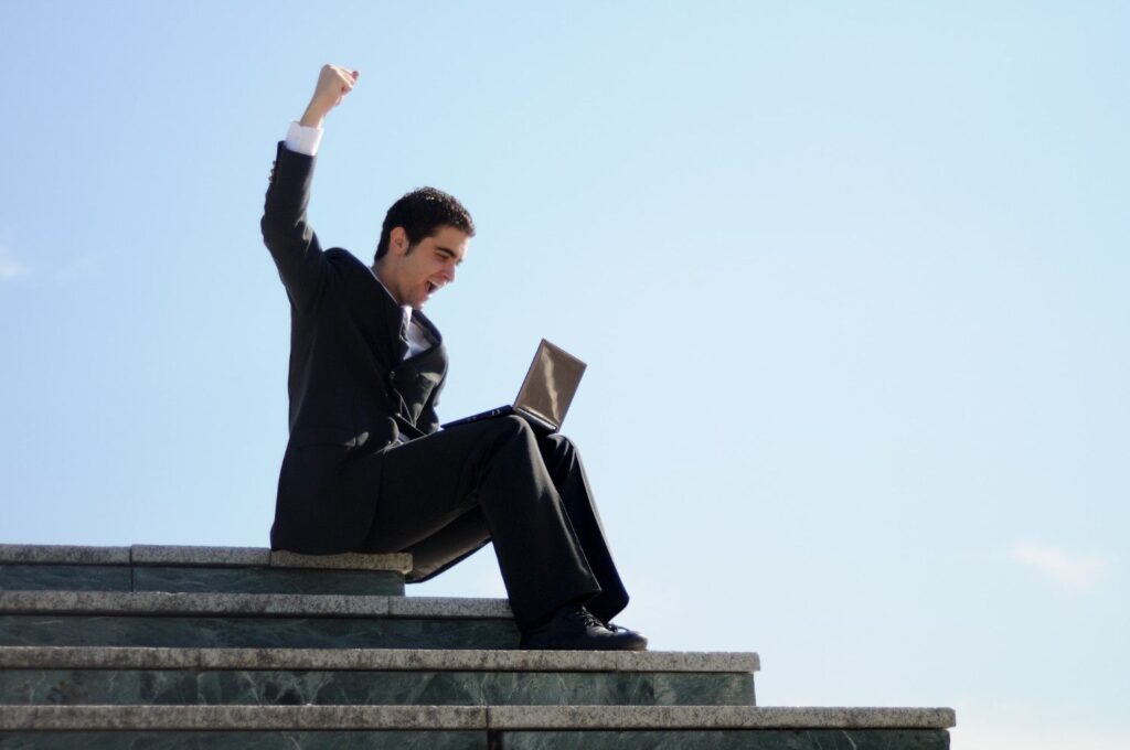 Man celebrating success while following a Self-Improvement Guide